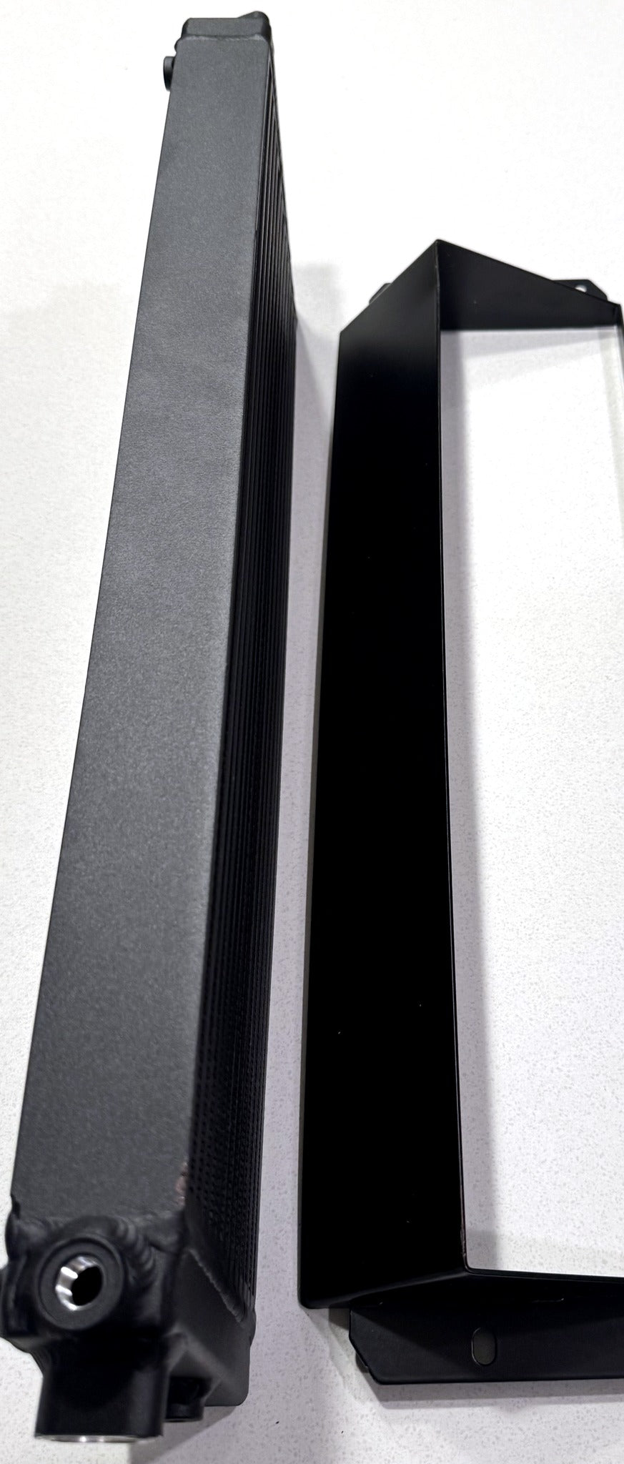 Side by side view of the W204 C63 oil cooler core thickness next to its mounting shroud