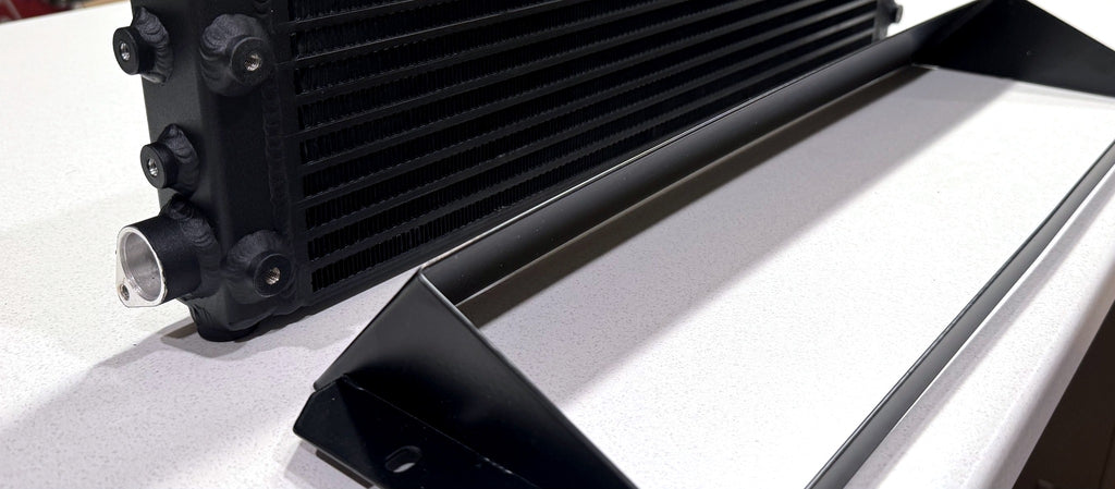 Dyne Performance USA W204 C63 oil cooler inlet and outlet fittings with shroud in foreground